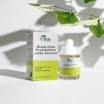 A 30ml bottle and packaging of Vita Elixia Bioactive Prebiotics Jelly Serum, formulated to strengthen the skin barrier, displayed under soft botanical leaf shadows