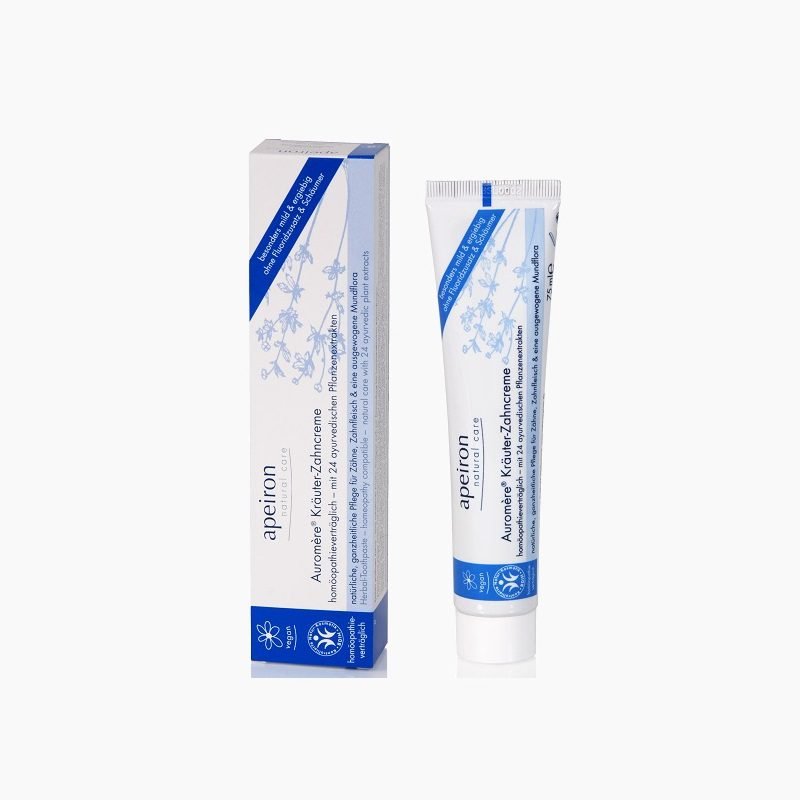 Apeiron Auromère ayurvedic herbal toothpaste tube standing next to its original blue and white product packaging