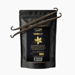 A sleek black 100g stand-up pouch of Blumental Bayern Vanilla, featuring two whole hand-selected vanilla beans resting on top of the packaging