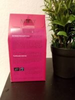 Moly Silhouette organic herbal tea box on a dark surface next to a green plant.