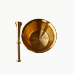 Top-down view of a polished gold brass mortar and pestle for grinding spices and herbs