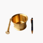 Polished gold brass mortar and pestle for grinding spices next to a black Blumental Bayern pen
