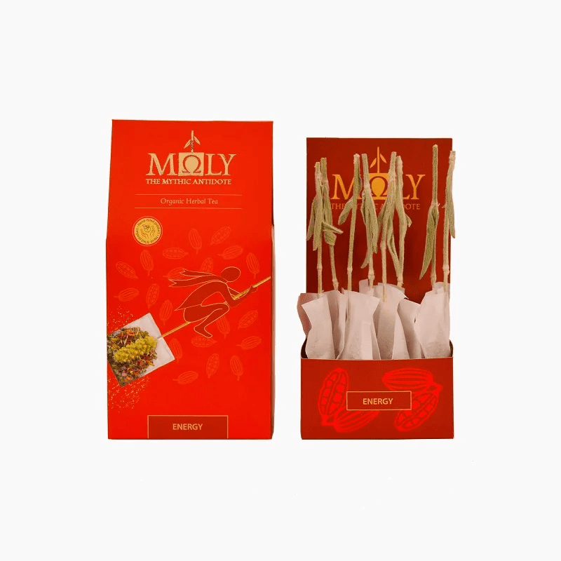 Moly Energy organic herbal tea in vibrant red packaging with open display box featuring artisanal herbal stem tea bags
