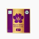 A premium purple and gold 5g for Blumental Organic Saffron, featuring a vibrant saffron crocus illustration and the German Bio-Siegel certification