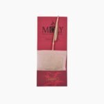 Moly Silhouette organic tea bag with a unique herbal stem handle on a pink and white minimalist background.